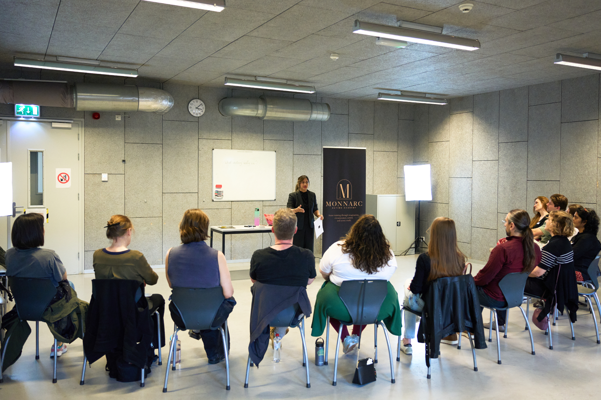Monnarc Foundation students in a circle during a group acting exercise at CREA Amsterdam.
